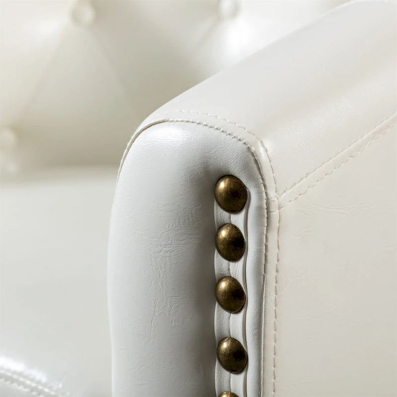 Fauteuil club en similicuir avec accoudoirs encastrés et garniture cloutée
